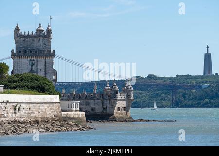 A beautiful shot of the Belem Tower, the 25th of April Bridge, and the Cristo Rei Monument in Lisbon Stock Photo