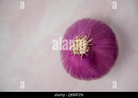 Top view of onion slices on pink background Stock Photo