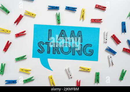 Text caption presenting I Am Strong. Business idea Have great strength being healthy powerful achieving everything Colorful Pegs Placed Around Speech Stock Photo