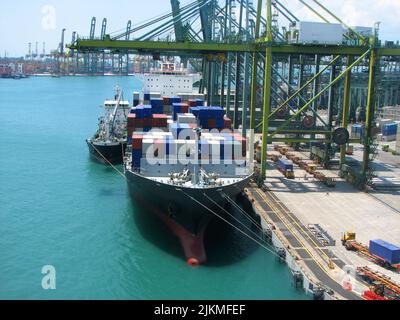 Bunkering tanker container ship in port Stock Photo