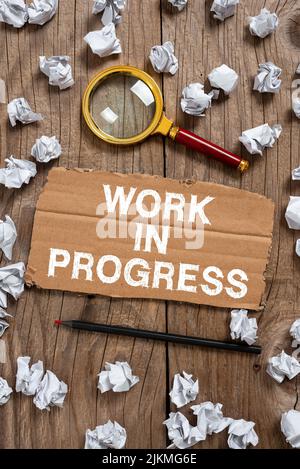 Conceptual display Work In Progress. Word for Job still being done developing project business strategy Cardboard With New Ideas With Paper Wraps Stock Photo