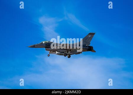 A Luke airbase f16 military plane flying in the vibrant cloudy sky in Phoenix, Arizona Stock Photo