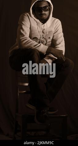 A cool young African American young guy posing in a studio Stock Photo