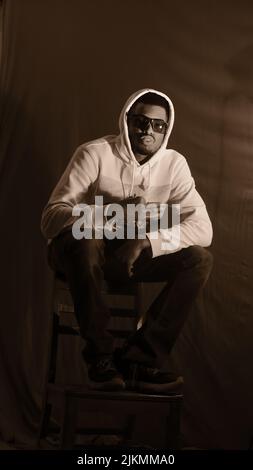 A cool young African American young guy posing in a studio Stock Photo