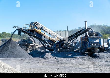 Mackay, Queensland, Australia - 7th June 2022: Machinery working in a quarry producing industrial rock and stone for construction of roads and other p Stock Photo