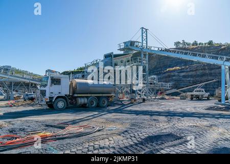 Mackay, Queensland, Australia - 7th June 2022: Infrastructure and the machinery working in a quarry producing industrial rock and stone for constructi Stock Photo