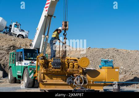 Mackay, Queensland, Australia - 7th June 2022: Worker on machinery in a quarry producing industrial rock and stone for construction of roads and other Stock Photo