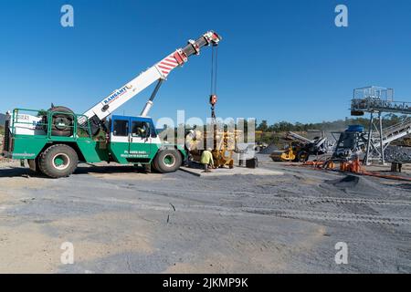 Mackay, Queensland, Australia - 7th June 2022: Crane working in a quarry producing industrial rock and stone for construction of roads and other purpo Stock Photo