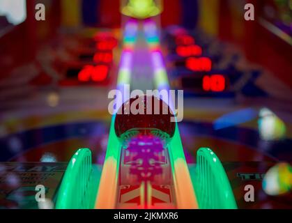 A low angle shot of a colorful arcade pinball game machine in Brighton Stock Photo