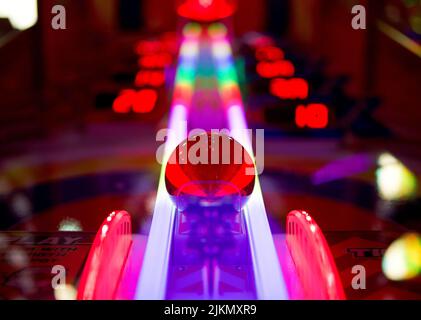 A low angle shot of a colorful arcade pinball game machine in Brighton Stock Photo