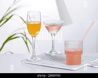 Three types of different cocktails on a cutting board on the table Stock Photo
