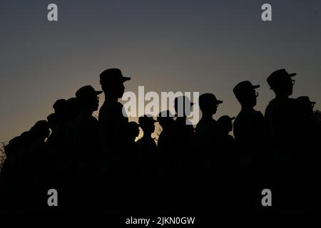 The silhouettes of rows of soldiers at dawn Stock Photo