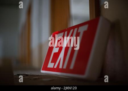 A closeup shot of the red steel LED Exit sign with white letters Stock Photo
