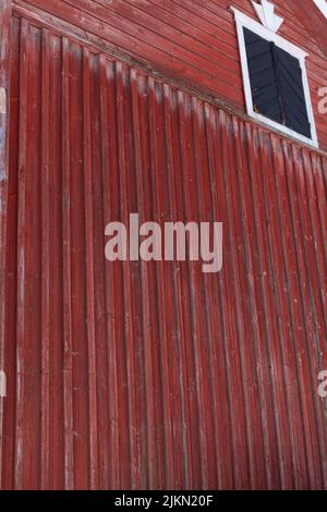 A vertical shot of a red, old wall of a house Stock Photo
