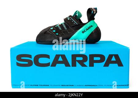 New women's shoe Scarpa Instinct VS isolated on white background. Rock climbing shoe for advanced climbers lying on a blue cardboard box. Stock Photo