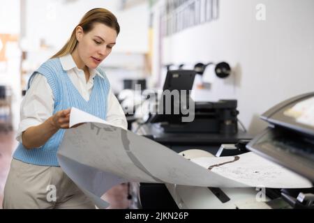 Worker in a printing and press centar check print quality Stock Photo