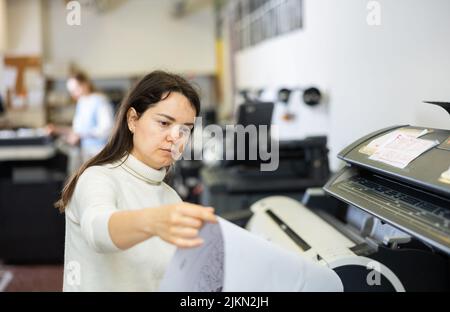 Worker in a printing and press centar check print quality Stock Photo