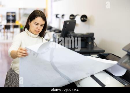 Worker in a printing and press centar check print quality Stock Photo