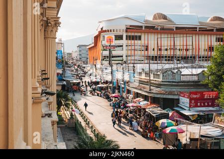 an informal street market and Burger King restaurant in central San Salvador, El Salvador. As viewed from a window of the National Palace Stock Photo