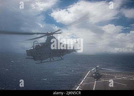 220730-N-XB010-1002 EAST CHINA SEA (July 30, 2022) A AH-1Z Cobra helicopter takes off from the forward-deployed amphibious transport dock ship USS New Orleans’ (LPD 18) flight deck. New Orleans, part of the Tripoli Amphibious Ready Group, along with the 31st Marine Expeditionary Unit, is operating in the U.S. 7th Fleet area of responsibility to enhance interoperability with allies and partners and serve as a ready response force to defend peace and stability in the Indo-Pacific region. (U.S. Navy photo by Mass Communication Specialist 1st Class Desmond Parks) Stock Photo