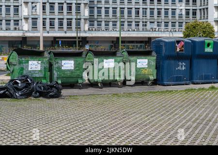 A row of large green and blue garbage containers in Lisbon, Portugal Stock Photo