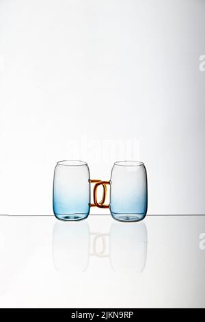 A closeup shot of two transparent glass tea cups isolated on a white background Stock Photo