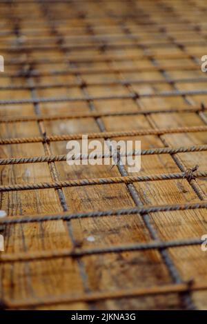 A vertical shot of a rusty concrete reinforcement steel bars Stock Photo