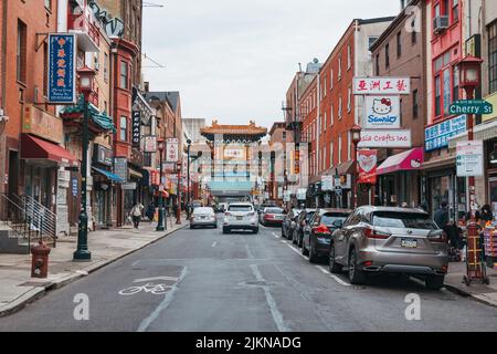 Looking down a street filled with restaurants, shops and other Chinese businesses in Chinatown, Philadelphia, USA Stock Photo