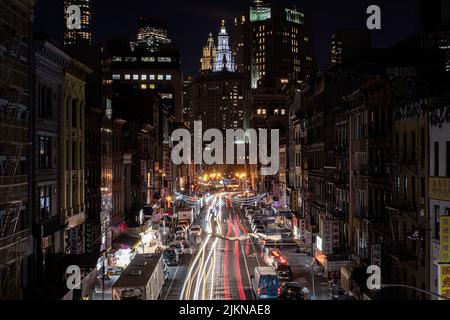 A landscape of New York city's Chinatown from the Manhattan Bridge at night Stock Photo