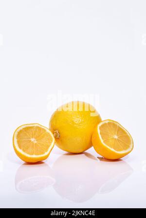 Whole and sliced lemon slices on  white background Stock Photo