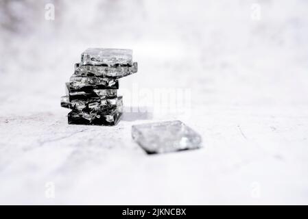 A stack of crystal stones on a white surface and background Stock Photo
