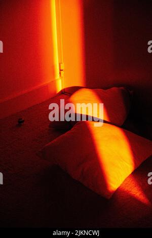 A vertical shot of an illuminated room with light on the couch Stock Photo