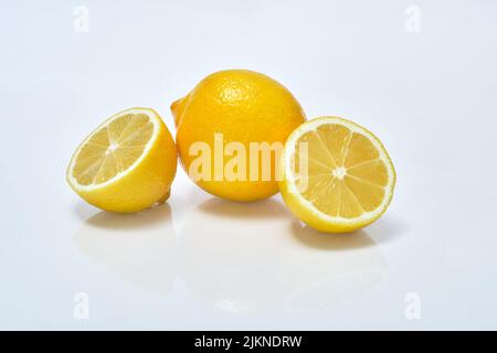 Whole and sliced lemon slices on  white background Stock Photo