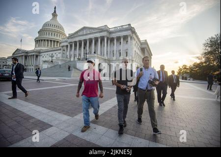 Veterans advocate John Feal, left, and Comedian and Activist Jon Stewart, center, walk to a press conference after the Senate passed the PACT Act, a bill to expand health care benefits for veterans exposed to toxic burn pits, at the U.S. Capitol in Washington, DC on Tuesday, August 2, 2022. Demonstrators from veterans-rights groups including the Wounded Warriors Project, Burn Pit 360 and the American Legion have stood outside the Capitol in protest since last week, calling on the Senate to pass the bill. Photo by Bonnie Cash/UPI Stock Photo