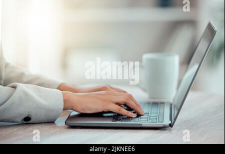 Hands checking, planning and typing on laptop while lawyer prepares contract, defense and closing arguments for paralegal court case. Closeup of Stock Photo