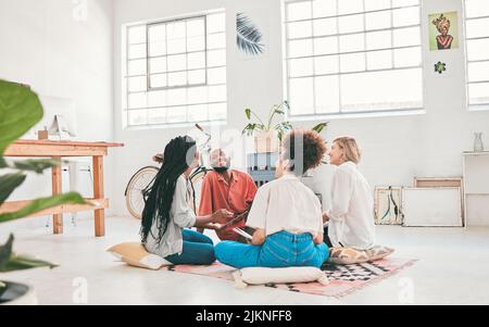 Happy, relaxed and talking business group laughing and bonding while working together in a modern office. Diverse designers brainstorming, sharing Stock Photo