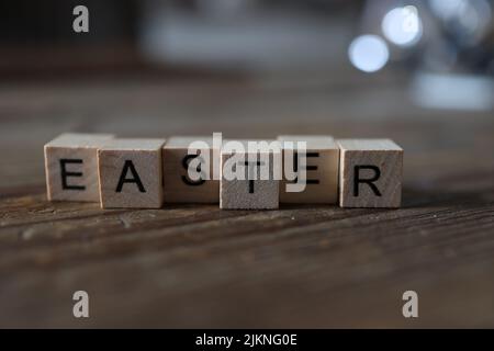 The word EASTER is laid out from wooden cubes. Stock Photo