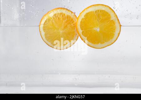 Lemon slices water splash, isolated on a white background Stock Photo