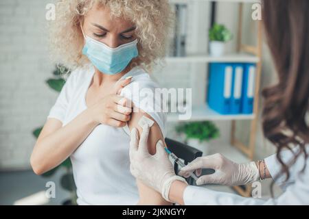 Portrait doctor's hands holding syringe making covid 19 vaccination in patient's arm. Coronavirus vaccination. Medicine medical health. Hand virus Stock Photo