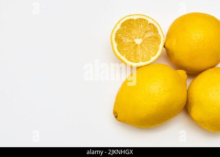 Whole and sliced lemon slices on white background Stock Photo
