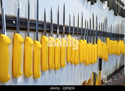 focus on center. yellow knife heap, modern industry details. Stock Photo