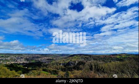 A scenic shot of mountains surrounding the city under the cloudy sky Stock Photo
