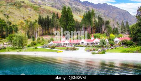 A large historic red building near the Wakatipu lake in Walter Peak high country farm Stock Photo