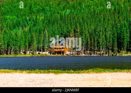 A beautiful shot of green forested hill seen from another side of river in spring Stock Photo