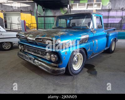 Avellaneda, Argentina - Mar 19, 2022 - old blue unpainted Chevrolet Chevy C10 Apache pickup truck 1960-1961 parked in a warehouse yard. Utility or far Stock Photo