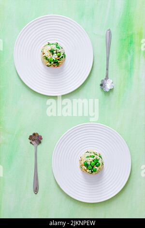 A vertical top view of two plates with rice and vegetables on aesthetic light green background Stock Photo