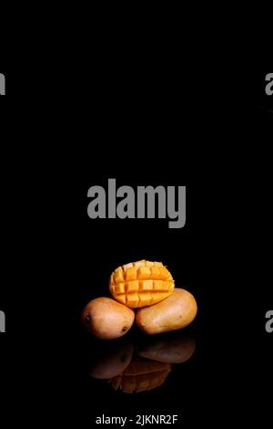 A fresh ripe mango isolated on black background Stock Photo