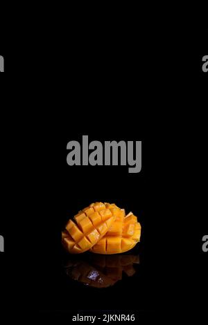 A fresh ripe mango isolated on black background Stock Photo