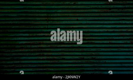 A closeup of a rusty dark green textured metal surface. Stock Photo
