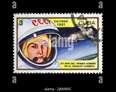 Valentina Tereshkova, astronaut , first woman in space, rocket shuttle Vostok 6, circa 1981. vintage postal stamp isolated on black background. Stock Photo